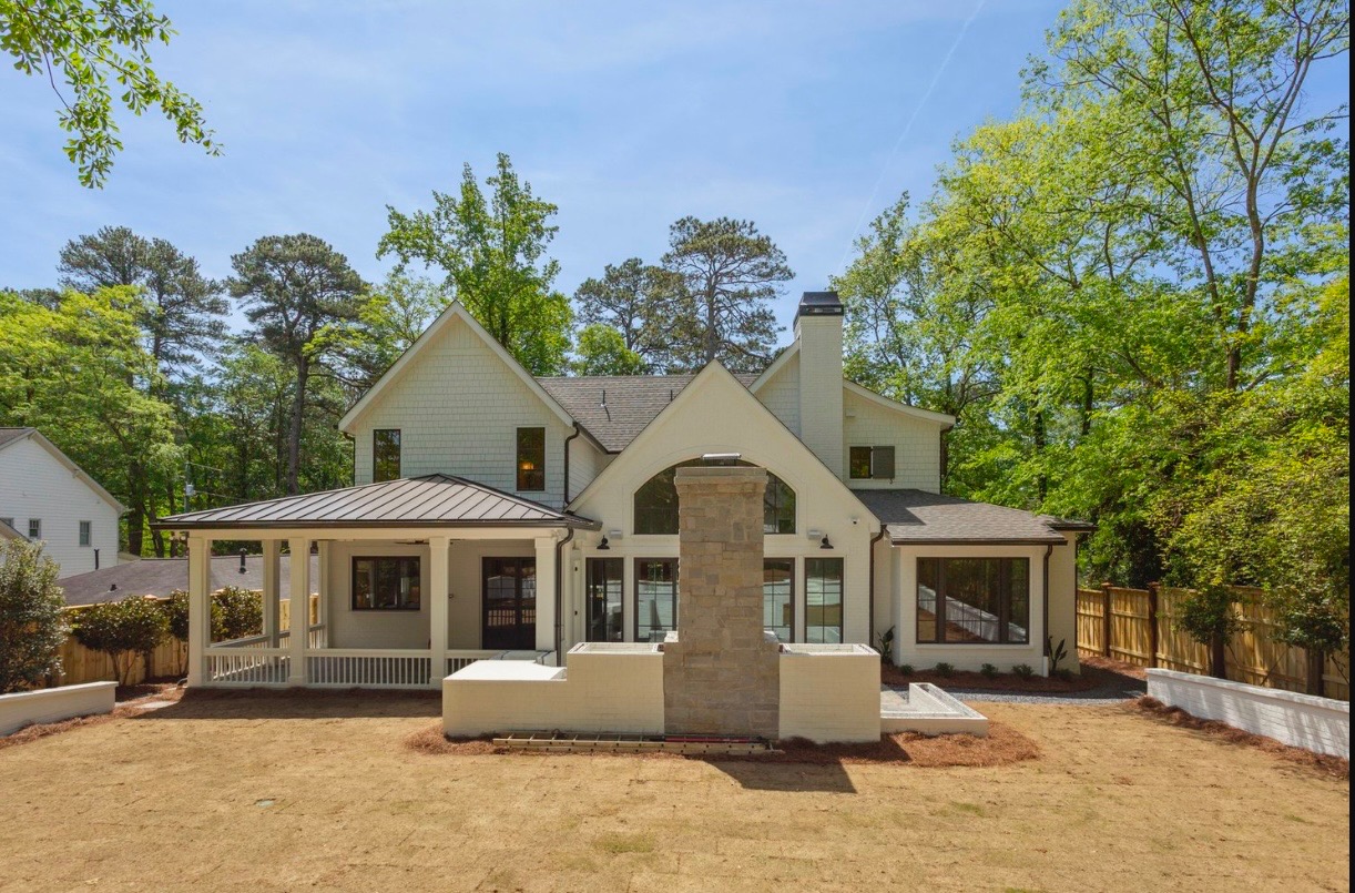 Completed exterior with hardscape, fresh sod, and pine straw beds
