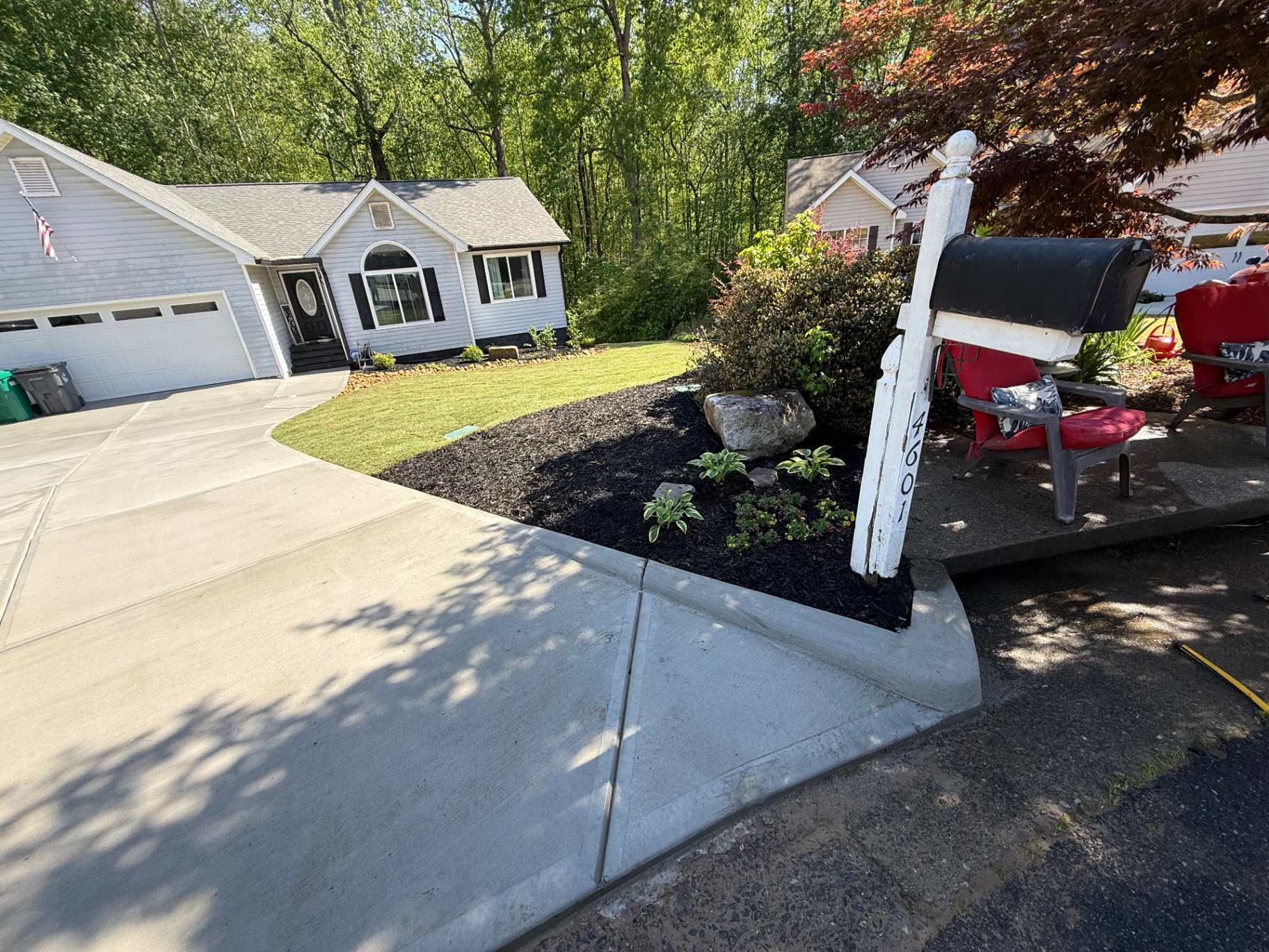Front yard landscaping with fresh mulch and concrete curb